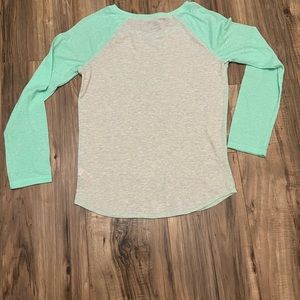 Never been worn blue/green long sleeve justice shirt. Kids size 12 comfy+cute!